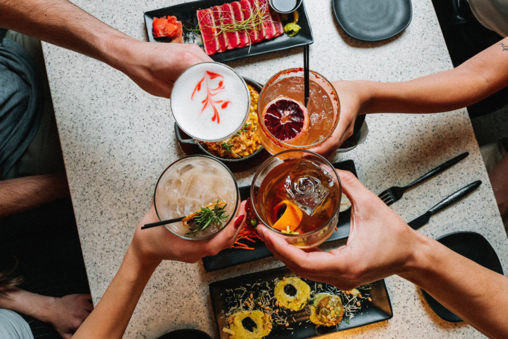 Friends cheering drinks at the table